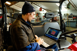 Mechanic using a laptop to diagnose at Winton Motorcycles
